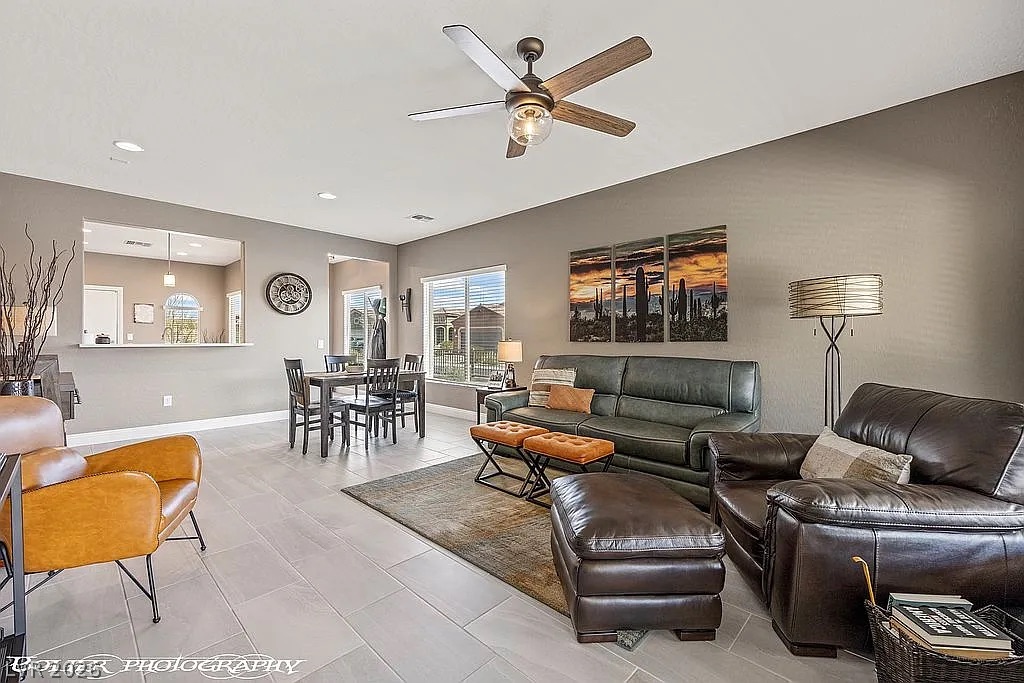 1304 Cottage Ridge Mesquite, NV 89034 - Photo 20 of 52 An open-concept living area boasts a modern ceiling fan, offering comfortable air circulation throughout the space.