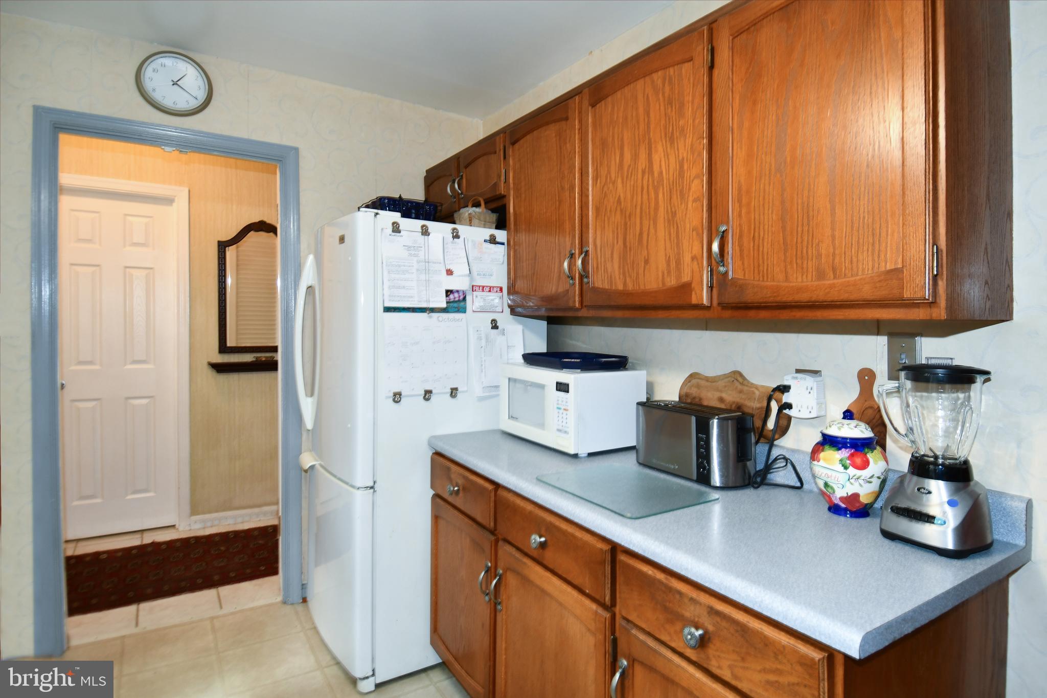 61 Oak Shade Road Gaithersburg, MD 20878 - Photo 11 of 42 a kitchen with refrigerator and cabinets
