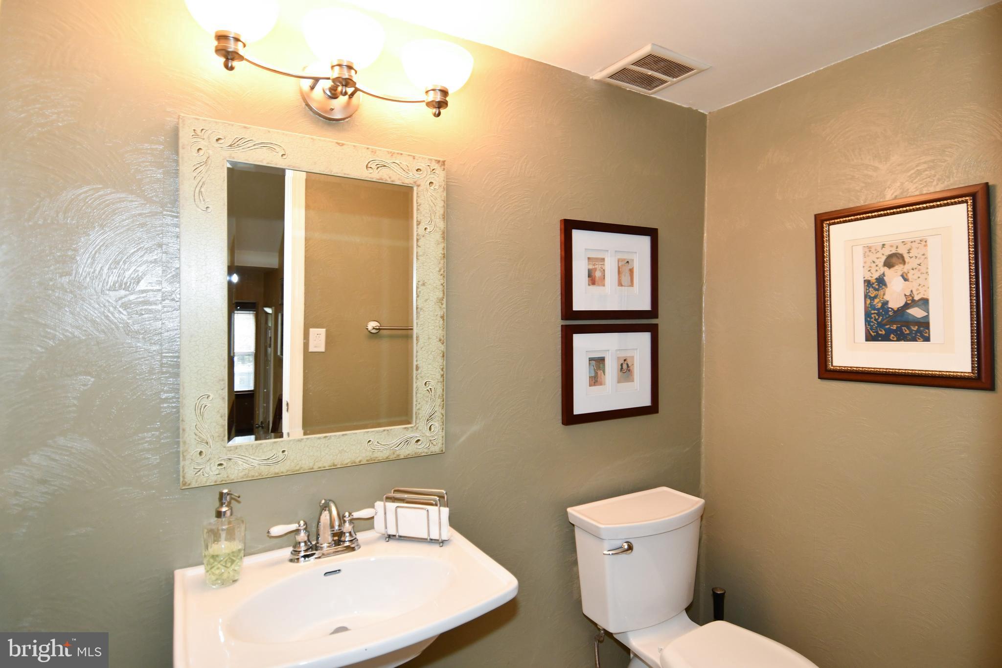 61 Oak Shade Road Gaithersburg, MD 20878 - Photo 19 of 42 a bathroom with a toilet a sink and mirror