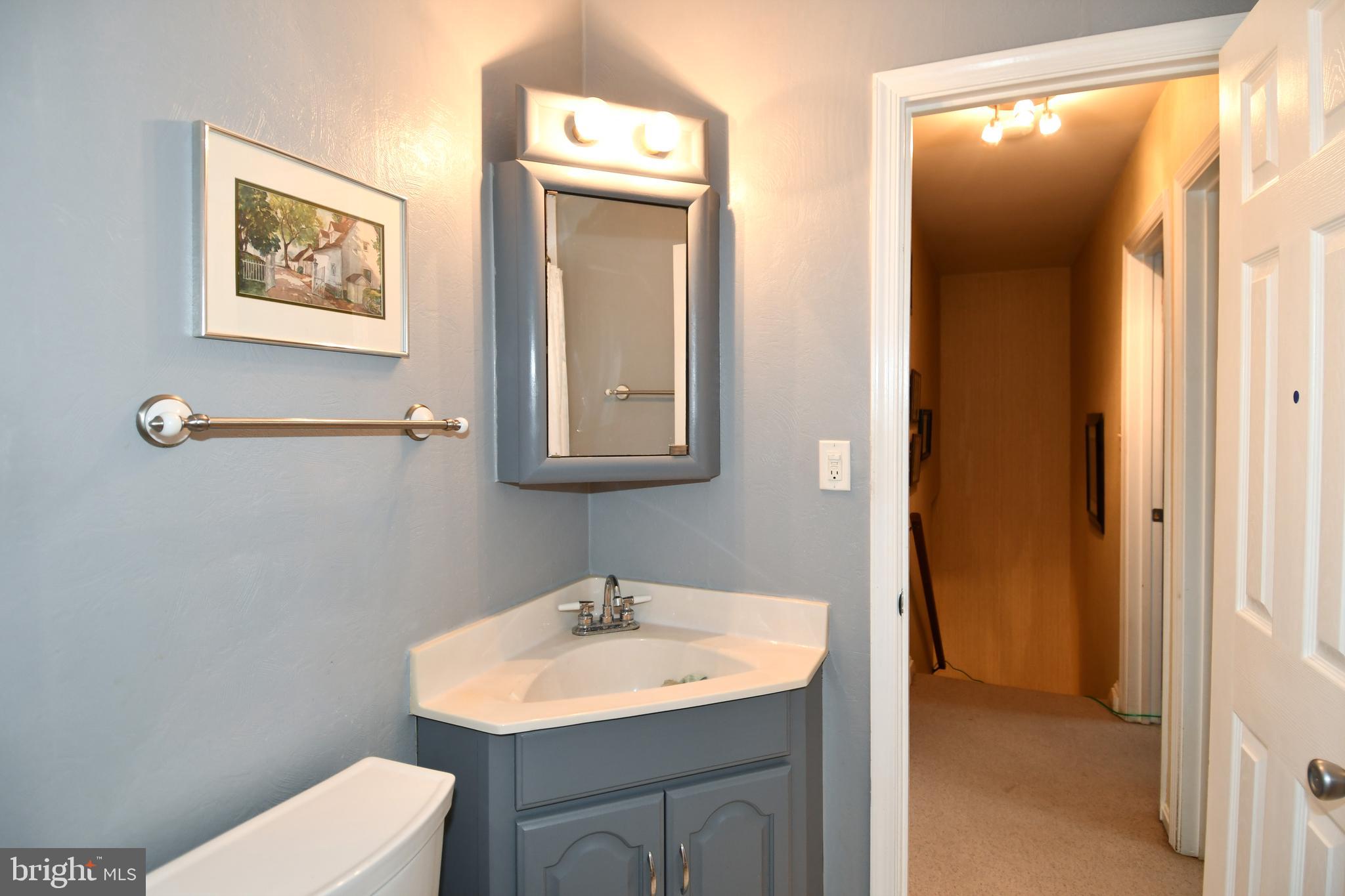 61 Oak Shade Road Gaithersburg, MD 20878 - Photo 34 of 42 a bathroom with a toilet sink and mirror