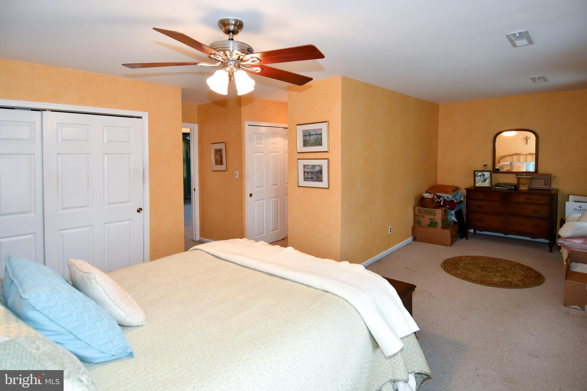 61 Oak Shade Road Gaithersburg, MD 20878 - Photo 37 of 42 a bedroom with a bed and a chandelier