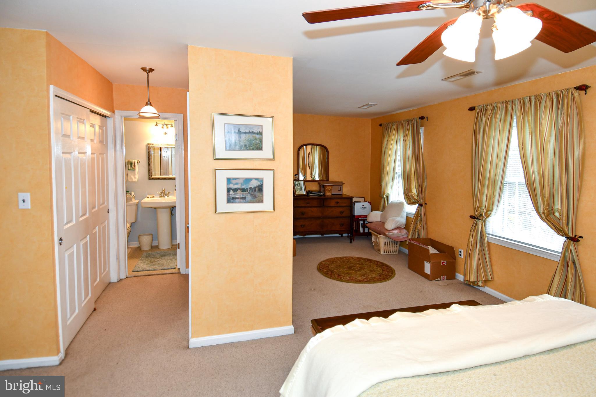 61 Oak Shade Road Gaithersburg, MD 20878 - Photo 39 of 42 a bedroom with a bed and a dresser next to a window