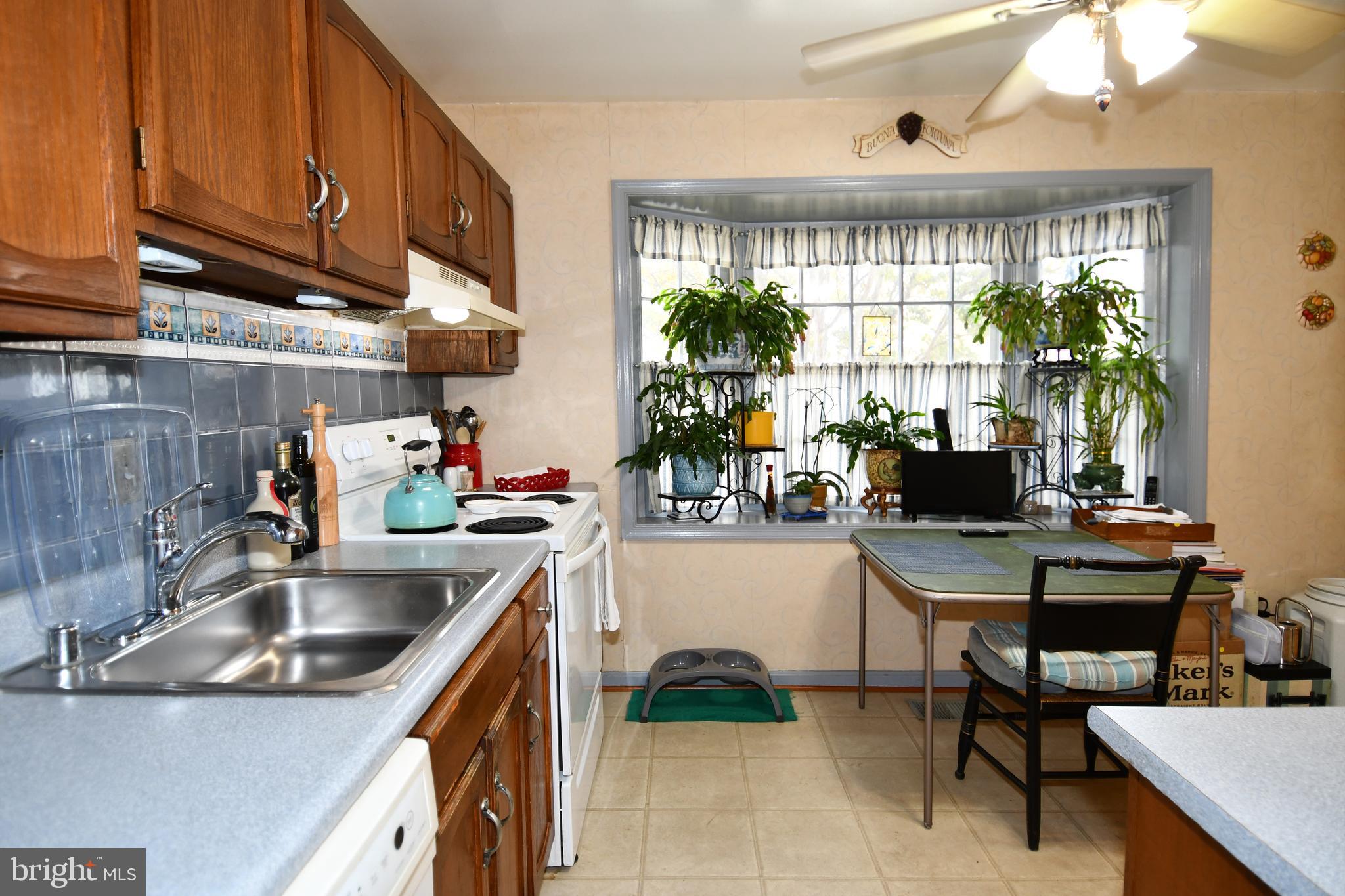 61 Oak Shade Road Gaithersburg, MD 20878 - Photo 9 of 42 a kitchen with a sink cabinets and a window