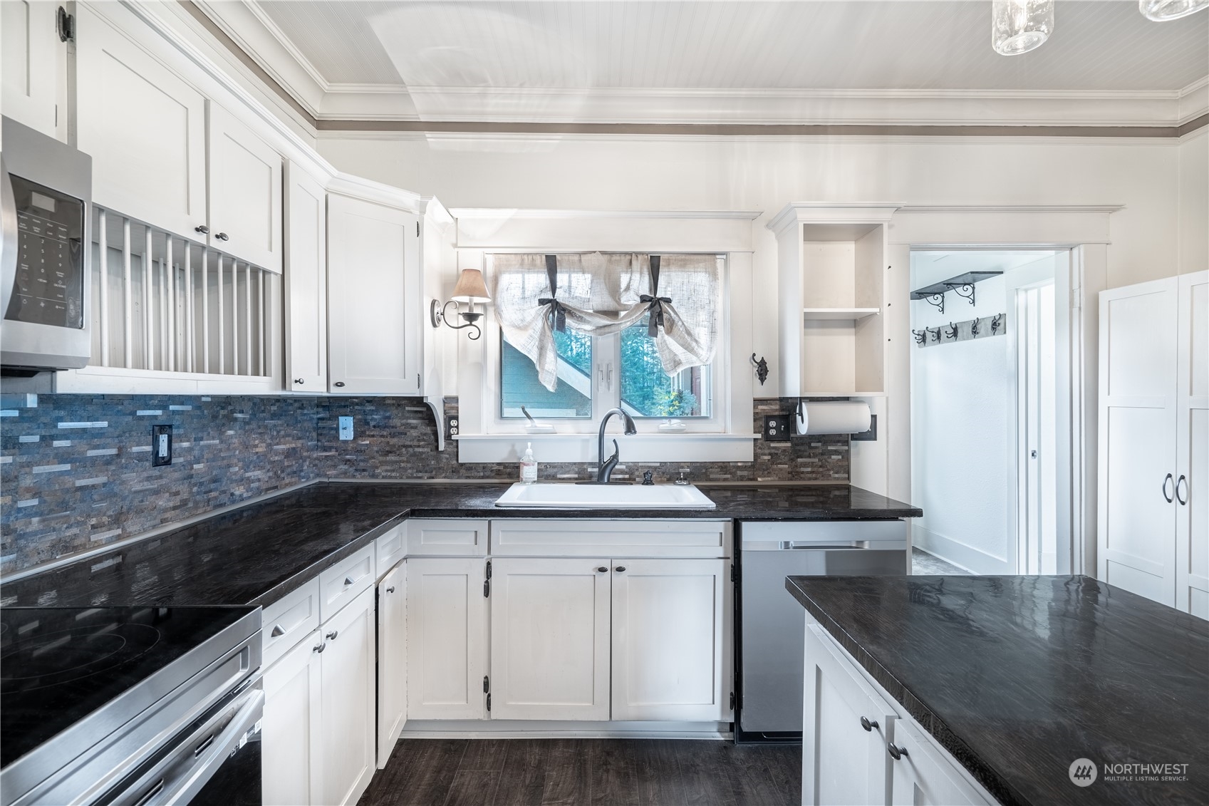 1049 Rush Road Chehalis, WA 98532 - Photo 13 of 40 a kitchen with a sink dishwasher a stove and white cabinets with wooden floor