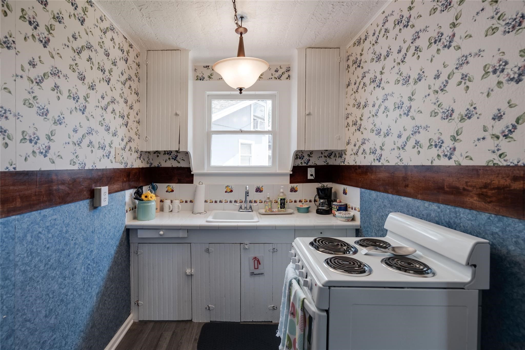507 8th Street Kemah, TX 77565 - Photo 18 of 50 a kitchen with a sink stove and cabinets