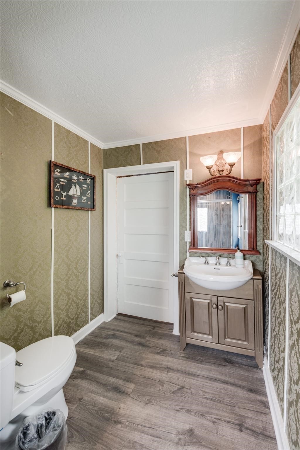 507 8th Street Kemah, TX 77565 - Photo 19 of 50 a bathroom with a sink a toilet and shower
