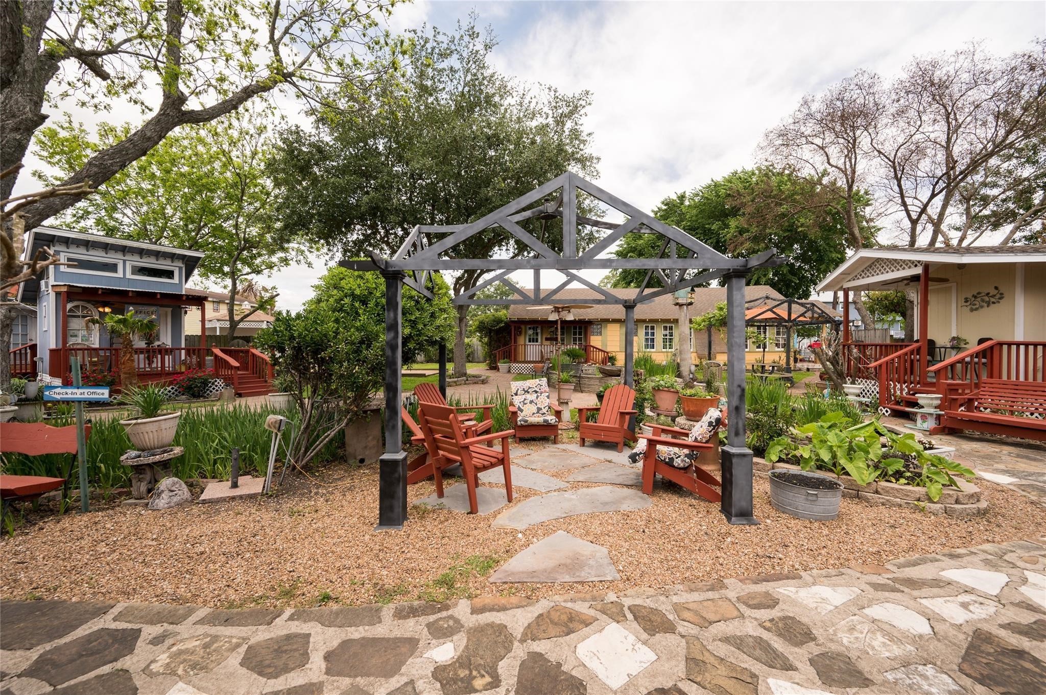 507 8th Street Kemah, TX 77565 - Photo 23 of 50 a view of a patio with table and chairs under an umbrella