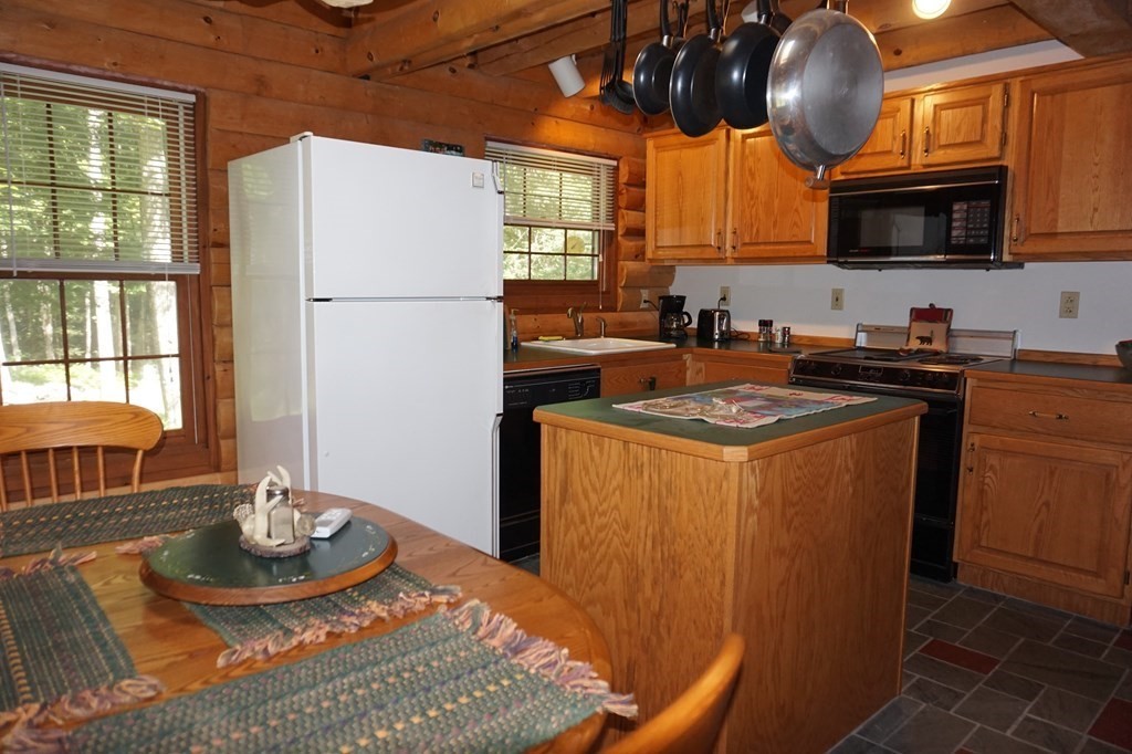 985 Willis Road Phillipston, MA 01331 - Photo 7 of 26 a kitchen with stainless steel appliances granite countertop a refrigerator a stove a sink a window and dining table