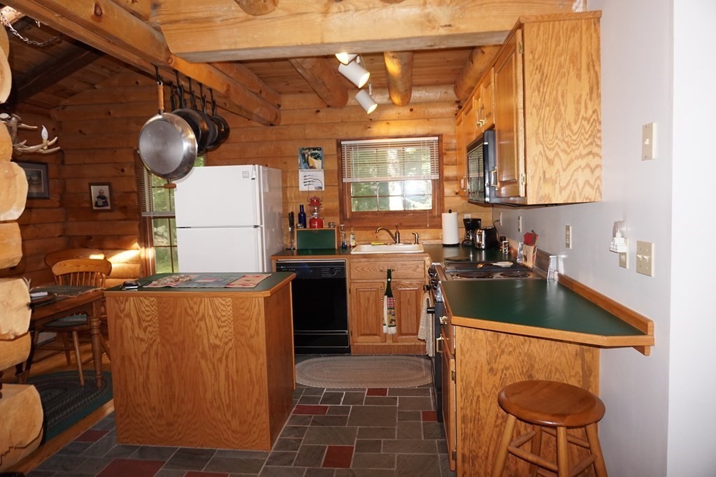 985 Willis Road Phillipston, MA 01331 - Photo 8 of 26 a kitchen with granite countertop a sink a stove and refrigerator