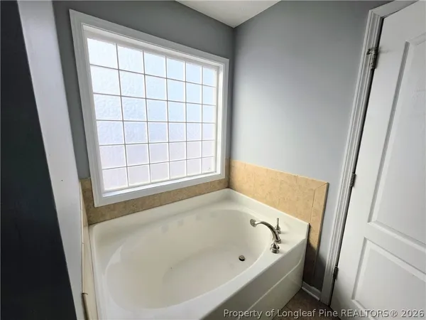 a bathroom with a bathtub and window