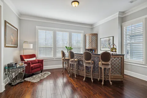 a kitchen with stainless steel appliances granite countertop a refrigerator a stove top oven a sink dishwasher and white cabinets with wooden floor