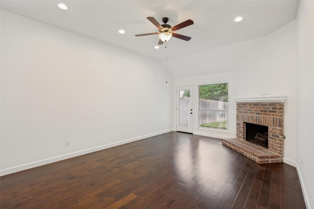 8160 Tower Road Frisco, TX 75035 - Photo 12 of 25 wooden floor in an empty room with a fireplace