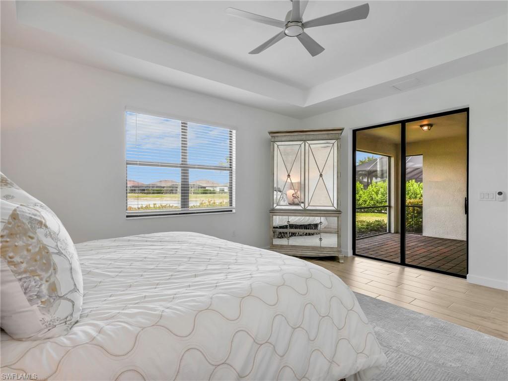 18278 Ridgeline Drive Estero, FL 33928 - Photo 17 of 45 a spacious bedroom with a large bed and a large window