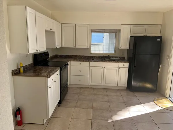 a kitchen with stainless steel appliances granite countertop a refrigerator and a stove