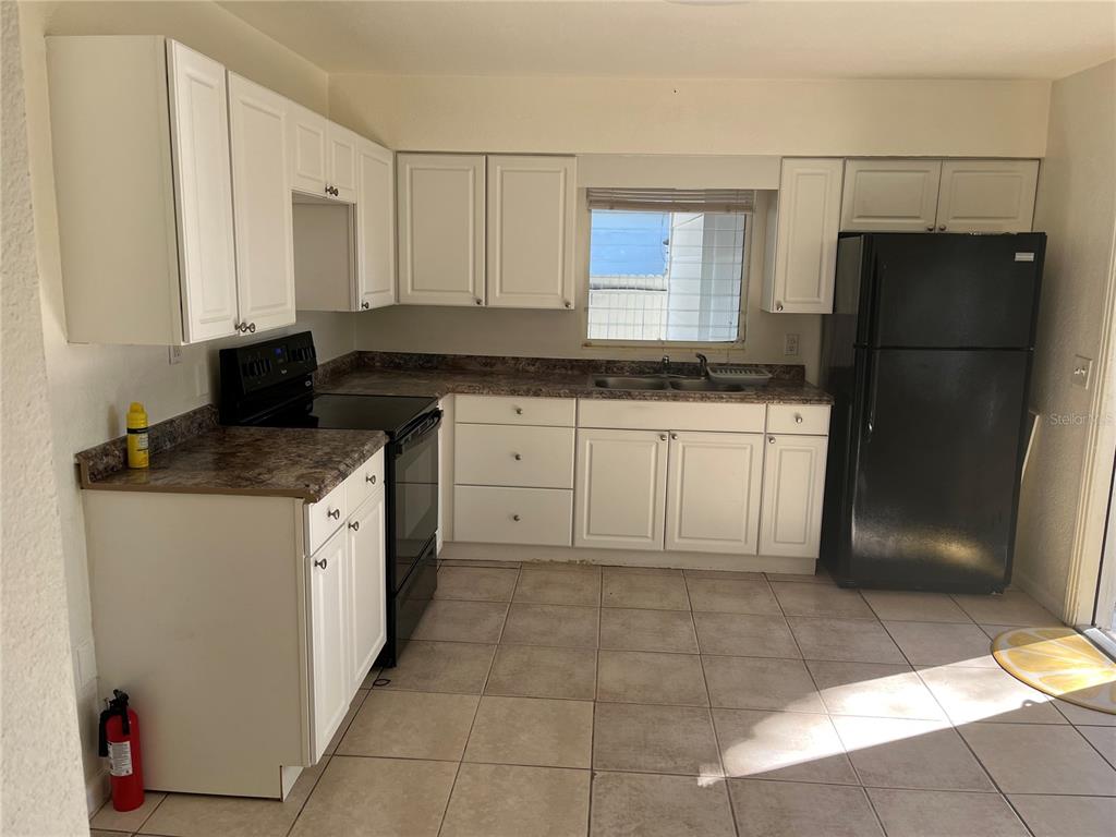 1485 Cleveland Street Clearwater, FL 33755 - Photo 2 of 14 a kitchen with stainless steel appliances granite countertop a refrigerator and a stove