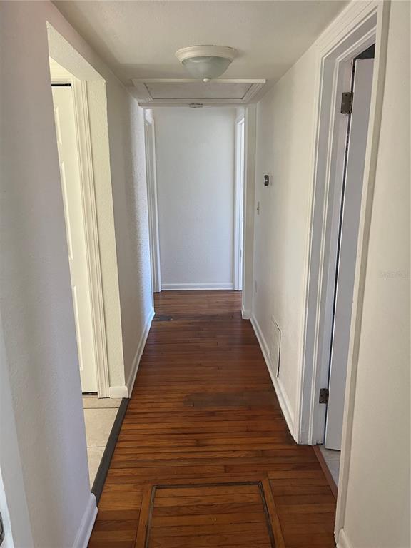 1485 Cleveland Street Clearwater, FL 33755 - Photo 8 of 14 a view of a hallway with wooden floor and staircase