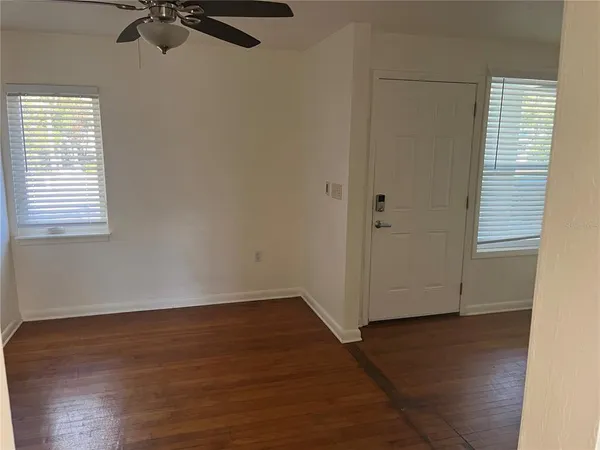wooden floor in an empty room with a window