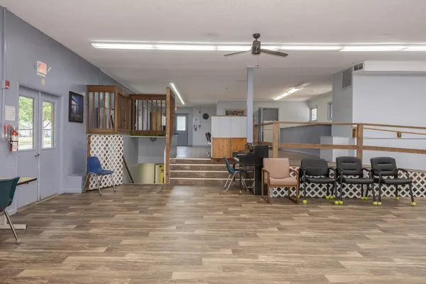 a kitchen with stainless steel appliances kitchen island granite countertop a refrigerator and cabinets