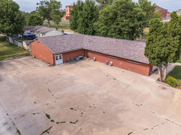 an aerial view of a house with a yard