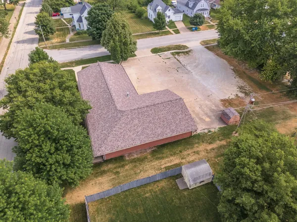 an aerial view of a house with a yard
