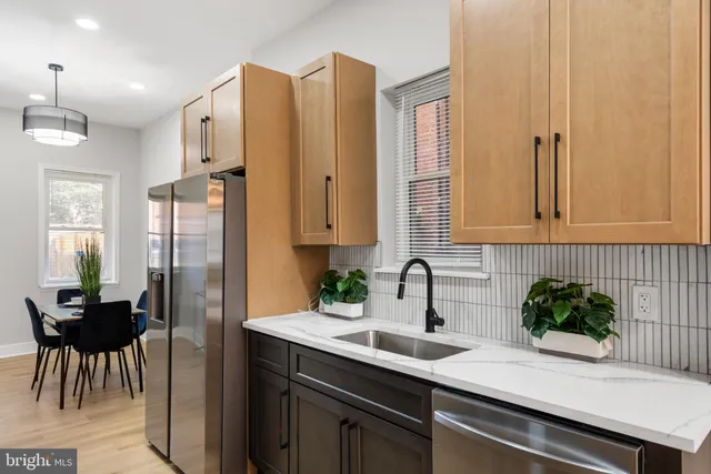 a kitchen with stainless steel appliances a refrigerator and a sink