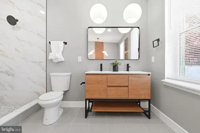 a white bath tub sitting next to a white cabinet