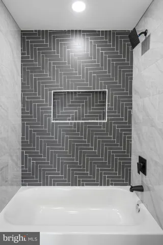 a bathroom with a granite countertop toilet sink and mirror