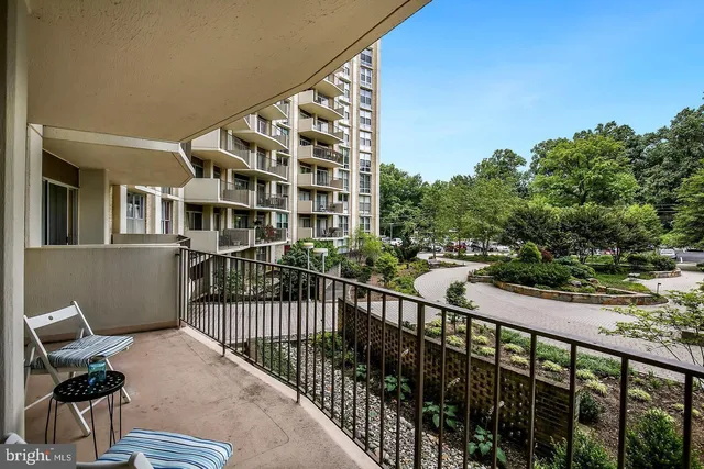 a view of a balcony with wooden floor and fence