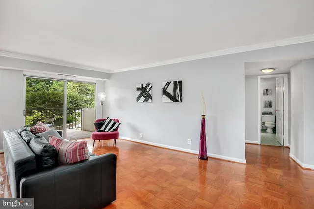 a living room with furniture and large windows