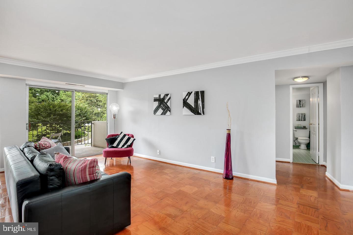 9039 Sligo Creek Parkway, Unit 205 Silver Spring, MD 20901 - Photo 5 of 28 a living room with furniture and large windows