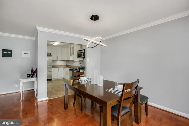 a view of a dining room with furniture and wooden floor