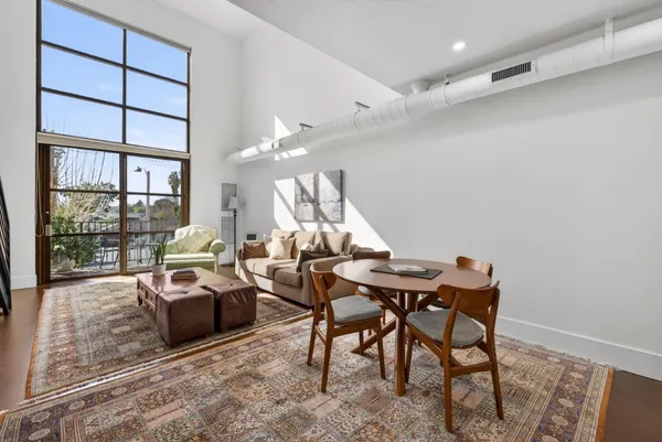 a living room with furniture a large window and a table