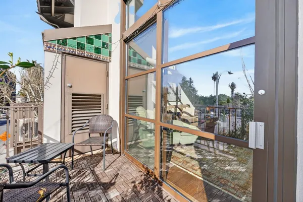 a view of a balcony with furniture
