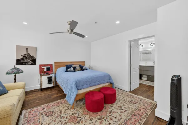 a bedroom with a bed and wooden floor