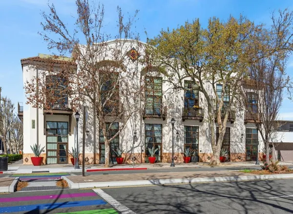 a outdoor view of a building with traffic signal lights