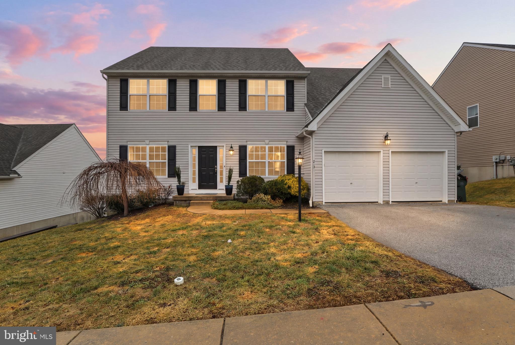 215 Azalea Drive Windsor, PA 17366 - Photo 2 of 68 a front view of a house with a yard and garage
