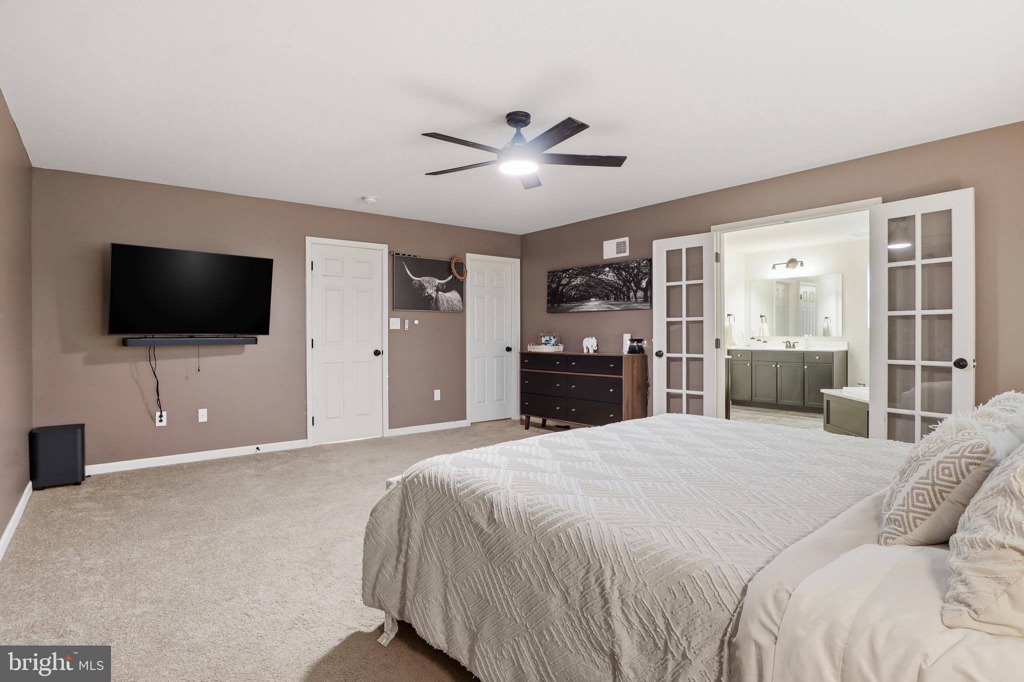 215 Azalea Drive Windsor, PA 17366 - Photo 34 of 68 a bedroom with a large bed and a flat screen tv