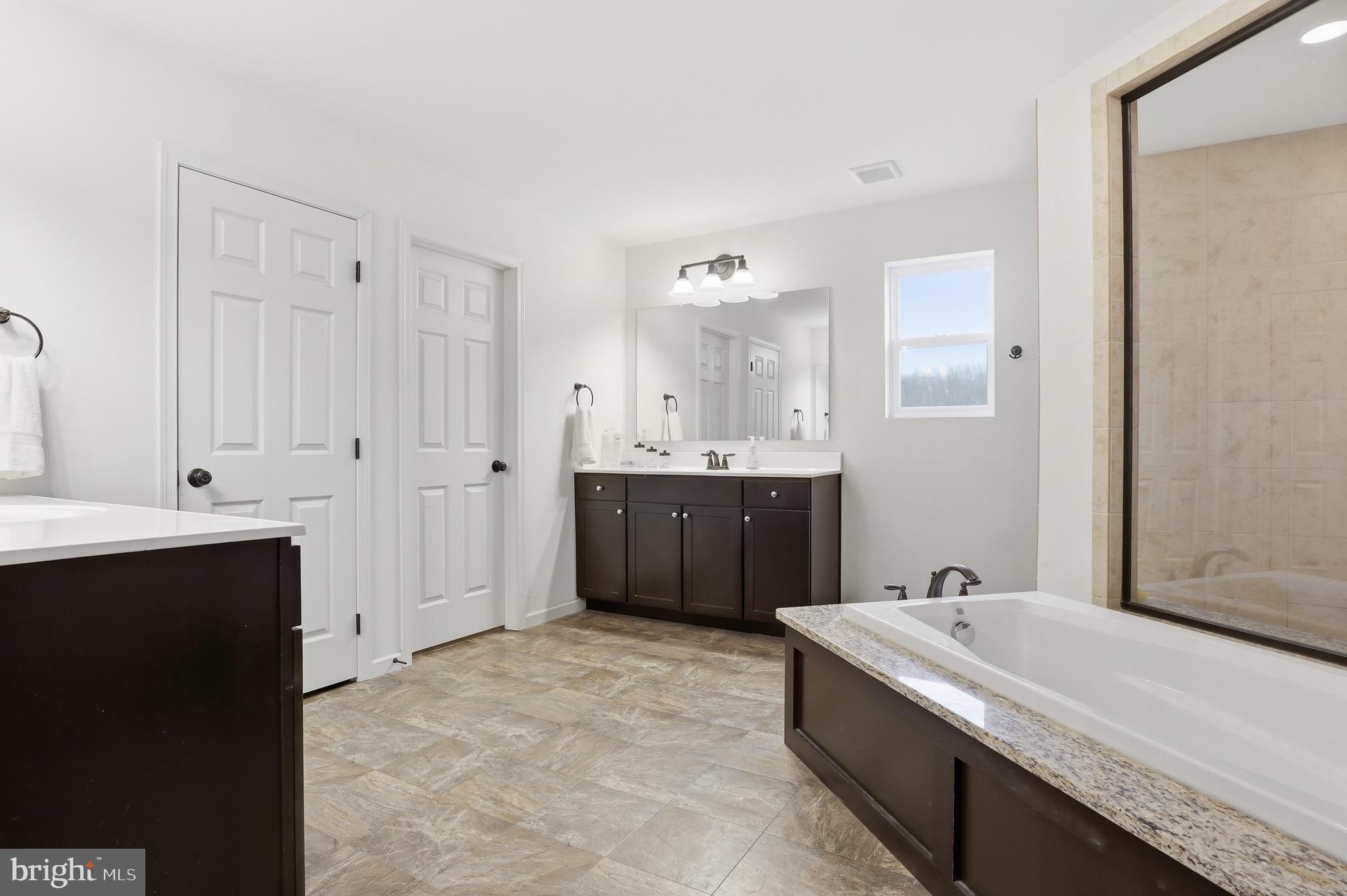 215 Azalea Drive Windsor, PA 17366 - Photo 35 of 68 a spacious bathroom with a bathtub sink and mirror