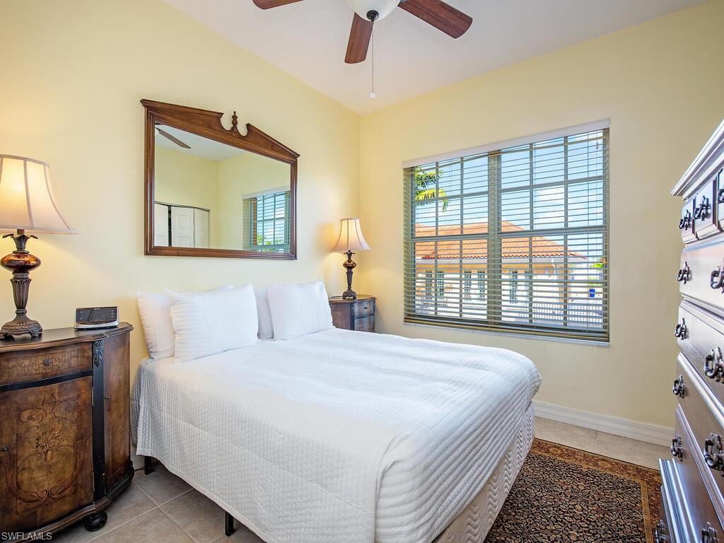 451 Bayfront Place, Unit 5311 Naples, FL 34102 - Photo 11 of 22 a bedroom with a bed and wooden floor