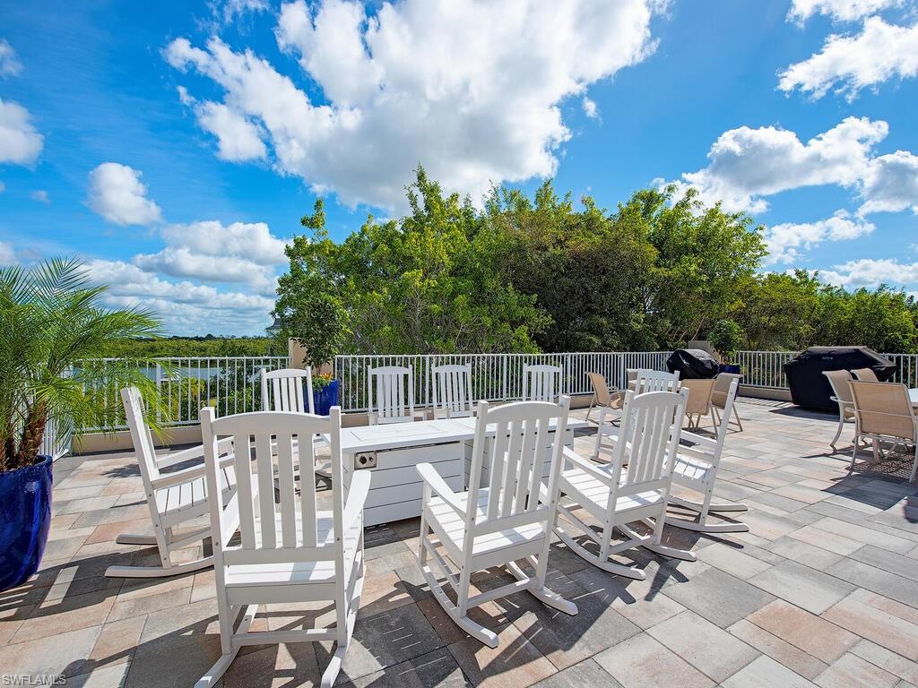 451 Bayfront Place, Unit 5311 Naples, FL 34102 - Photo 13 of 22 a view of a patio with table and chairs and potted plants