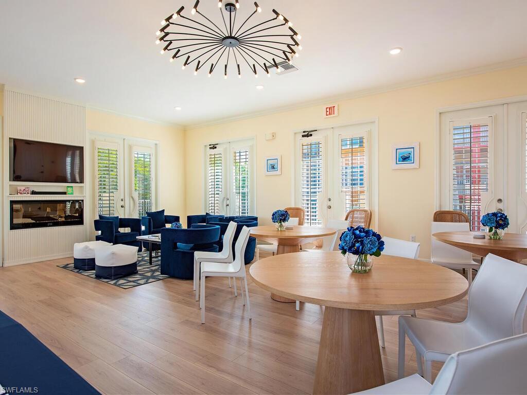 451 Bayfront Place, Unit 5311 Naples, FL 34102 - Photo 21 of 22 a living room with fireplace furniture and a flat screen tv