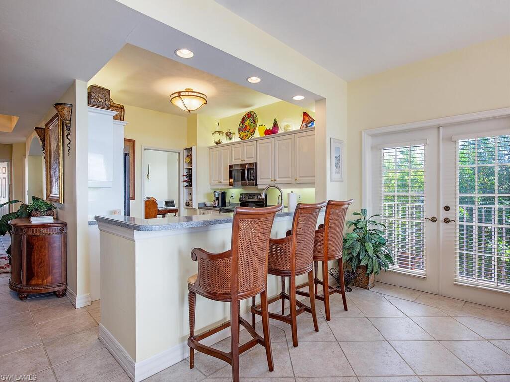 451 Bayfront Place, Unit 5311 Naples, FL 34102 - Photo 4 of 22 a large kitchen with a table and chairs