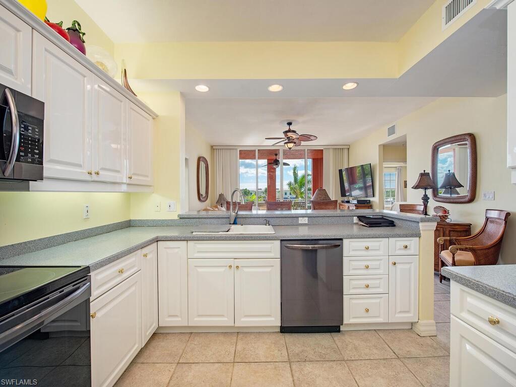 451 Bayfront Place, Unit 5311 Naples, FL 34102 - Photo 5 of 22 a kitchen with a sink and cabinets