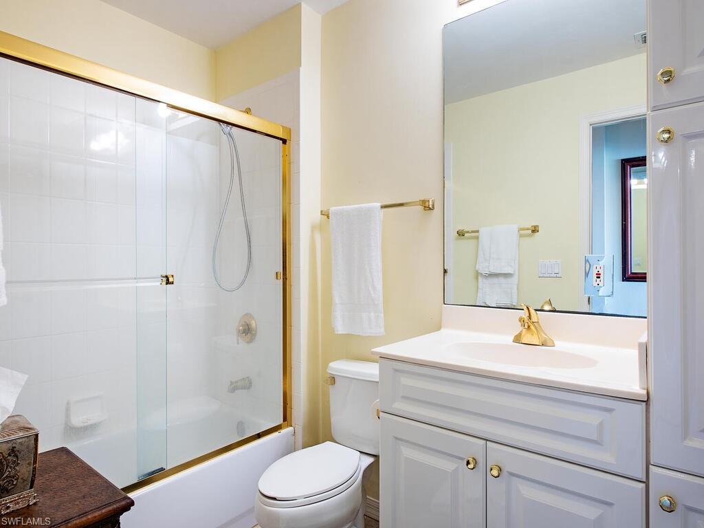 451 Bayfront Place, Unit 5311 Naples, FL 34102 - Photo 10 of 22 a bathroom with a sink a toilet and shower