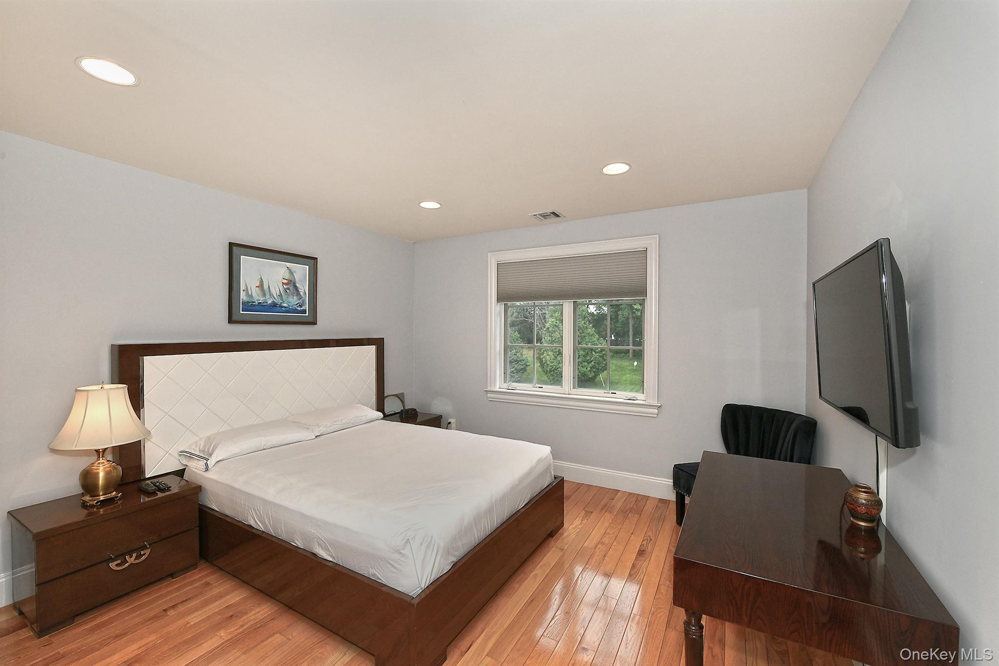 14 Norgate Road Glen Head, NY 11545 - Photo 25 of 44 a bedroom with a bed and a flat screen tv