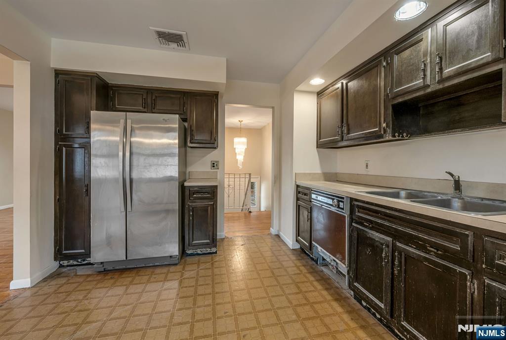 415 Goffle Road Wyckoff, NJ 07481 - Photo 12 of 30 a kitchen with stainless steel appliances granite countertop a refrigerator a sink and a stove