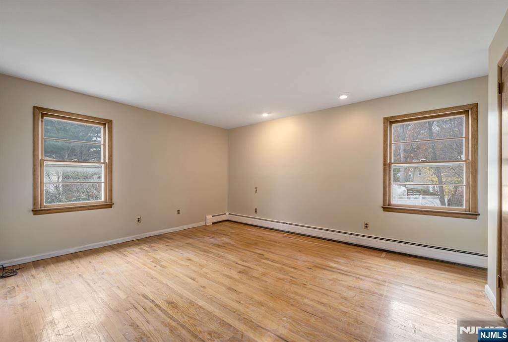 415 Goffle Road Wyckoff, NJ 07481 - Photo 14 of 30 a view of an empty room with wooden floor and a window