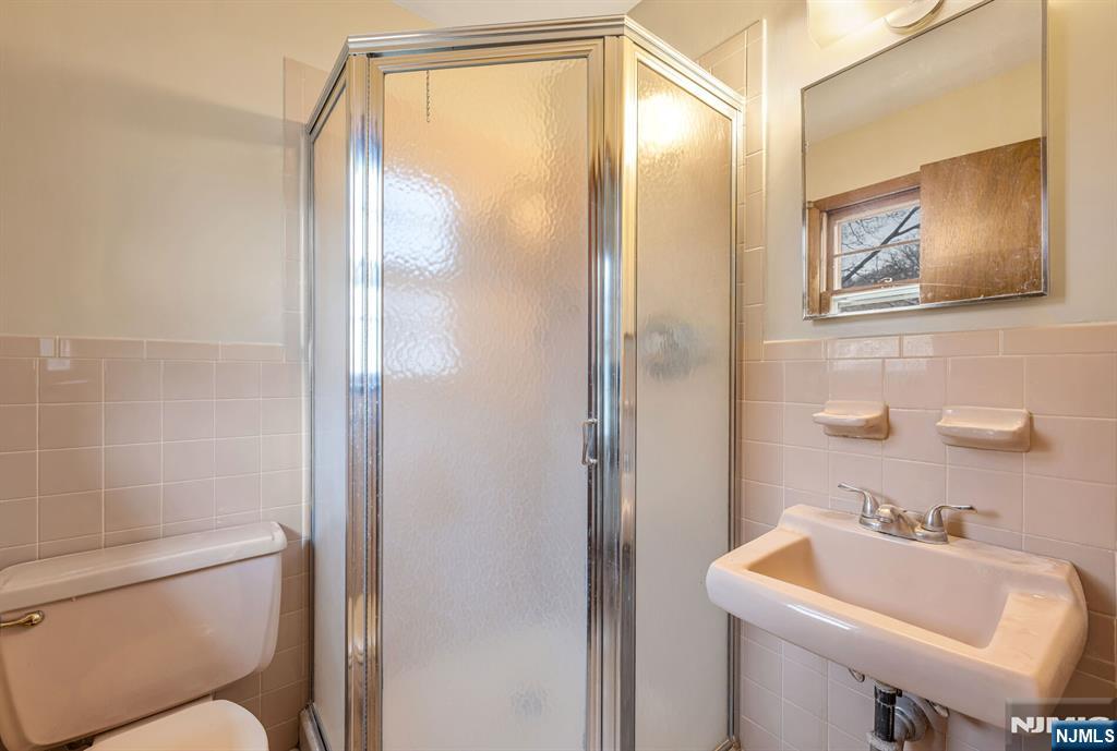 415 Goffle Road Wyckoff, NJ 07481 - Photo 16 of 30 a bathroom with a sink toilet and mirror