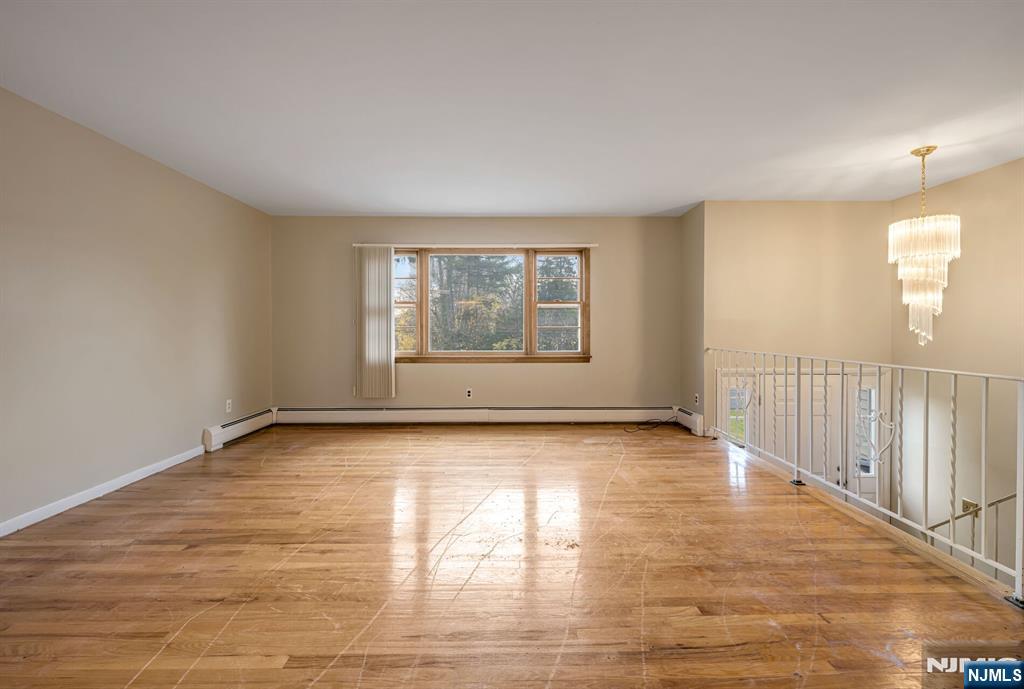 415 Goffle Road Wyckoff, NJ 07481 - Photo 7 of 30 a view of an empty room with wooden floor and a window