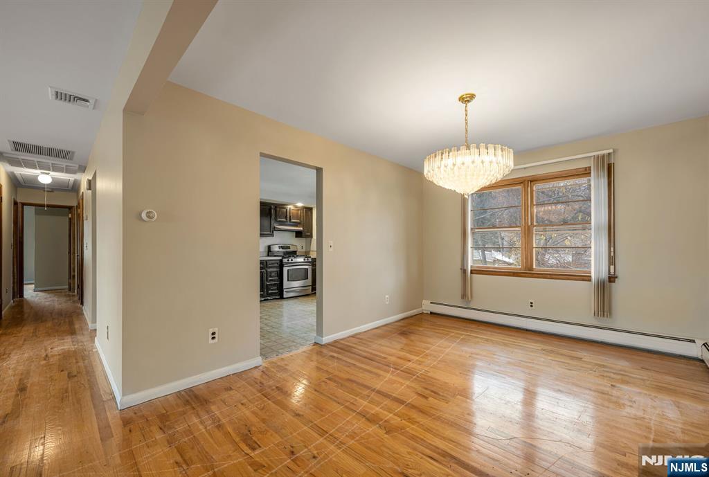 415 Goffle Road Wyckoff, NJ 07481 - Photo 9 of 30 a view of an empty room with window and wooden floor